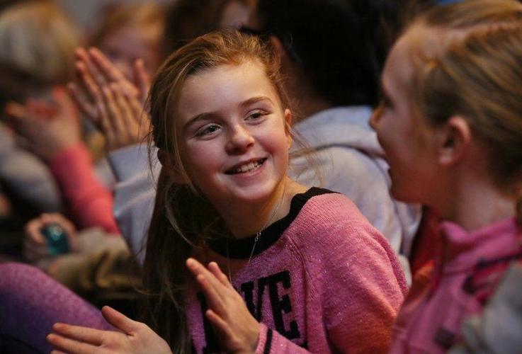 A young audience member smiling during a Cape Ann Symphony Youth Concert